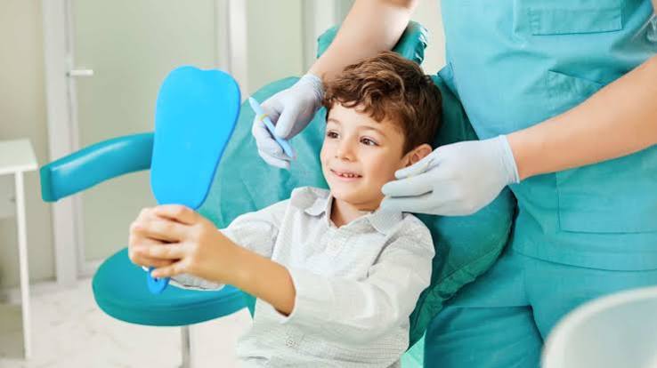 Child receiving a dental examination in a comfortable dental chair